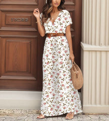 Modelo de frente usando o Vestido Longo Sevilla branco com estampa paisley e cinto ajustável.