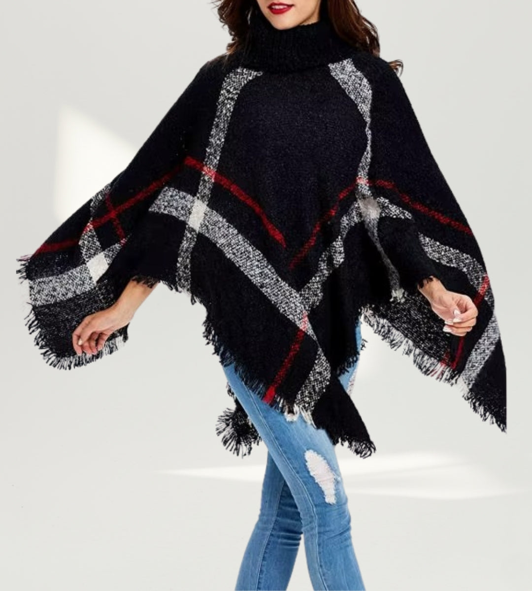 Composição de moda destacando o Poncho Isolde como peça statement para os dias frios.
