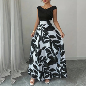 modelo mostrando vestido-longo-feminino-floral frente preto e banco 